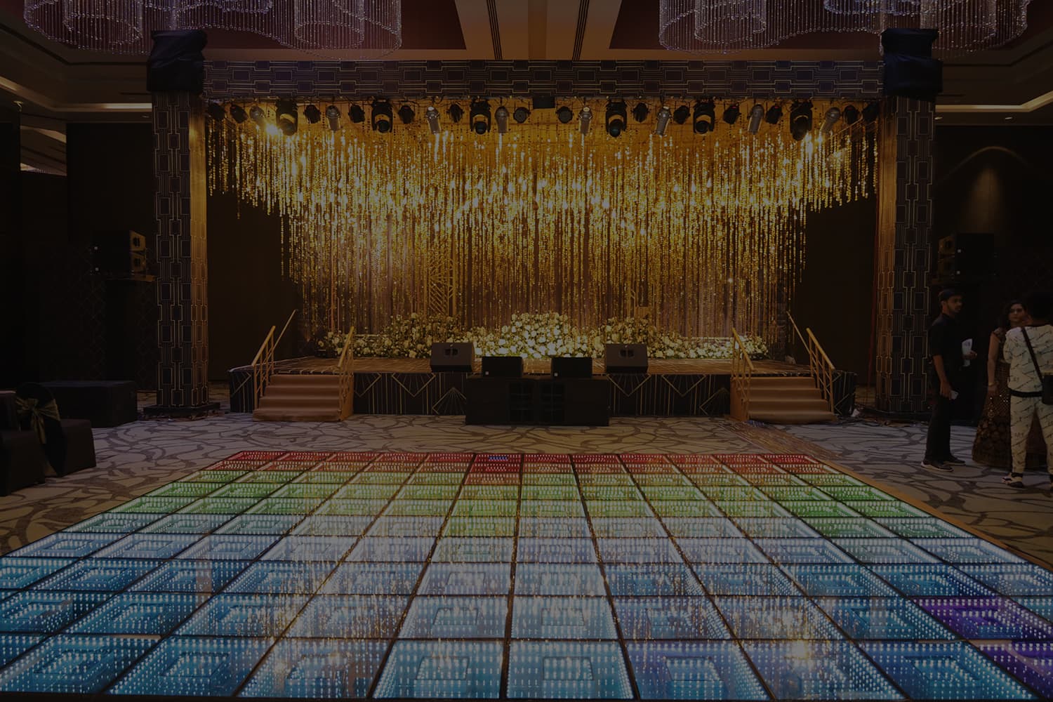 Corporate event stage with lighting by Curate Events